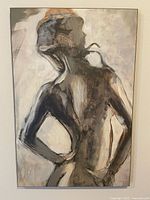 Photo of abstract back of a woman painting with muted mixed tones and ready-to-hang brass hanging hardware visible on back side.