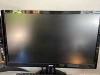 Front view of one Acer black ultra-thin monitor showing large screen and Acer logo on bottom bezel