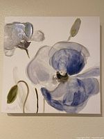 Front view of the first floral painting with a large blue and white flower and green stem on white background