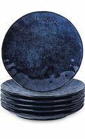 Stack of six dark blue porcelain dessert plates with a glossy, uneven glaze finish and curved design.