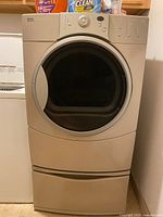 Front view of dryer closed, showing exterior door, control panel, and pedestal drawer closed