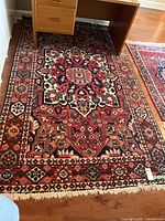 Full view of rug under desk showing overall design and condition