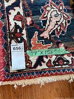 Close-up of corner showing green tape with dimensions '118" x 156"' and lot sticker