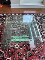 Three nested clear glass tables on patterned rug with all dimension labels visible