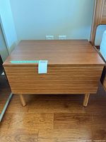 Wooden small side table closed, showing rectangular top and four round legs