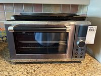 Front view of Paderno stainless steel toaster oven with control panel and closed door.