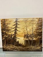 Full view of oil painting showing landscape with trees and water