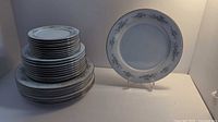 Stack of Noritake Melissa plates showing various sizes and floral silver-trimmed design