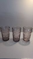Set of three pink embossed vintage drinking glasses with Pioneer Woman design.