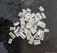 Loose diamonds scattered on black background