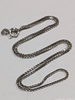 Full view of the sterling silver chain necklace with visible clasp and chain details.