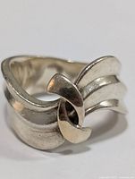 Front view of silver ring showing twisted knot design and polished finish.