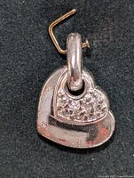 Front view of the silver heart-shaped pendant with cubic zirconia detailing and bail.