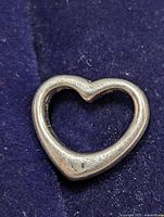 Front view of the silver heart-shaped pendant showing its shape and surface condition.