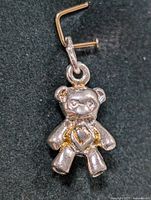 Close-up photo of the silver teddy bear pendant showing the heart detail on the chest.