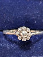 Close-up front view showing the floral cluster design on the silver ring.