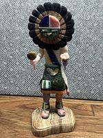 Full view of the 13-inch stone Kachina doll standing on a stone base with a multicolored headdress and detailed attire.