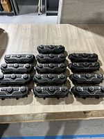 13 late model Jeep Wrangler AC climate control units arranged on a table showing the front controls and knobs.
