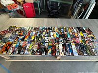 Overview of 85 comic books arranged on a table showing various titles and colorful covers.