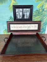 Full view of the wooden tray with metal embossed surface, holding the framed photo and quote sign arranged inside.