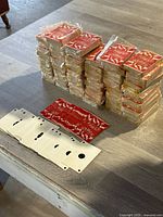 Stacked decks of Bowlo cards on table showing sealed packages and some opened decks with cards laid out