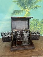 Open cabinet showing decanters and glasses on swing-out trays