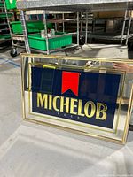 Mirror showing the full front including logo, frame, and reflective glass.