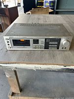 Front view of Onkyo TA-2022 cassette player showing full unit with cassette slot, control buttons, and various knobs.