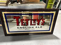 Front view of the Tetley's English Ale beer mirror sign showing logo and border details.