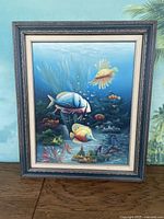 Full front photo of the framed underwater fish painting showing colorful marine scene.