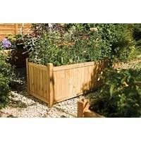 Garden planter assembled and filled with plants, showing example use of the rectangular wooden planter in an outdoor garden setting.