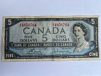 Front side of the 1954 Canadian $5 paper banknote showing Queen Elizabeth II portrait and serial number.