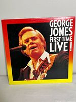 Front cover of George Jones First Time Live! vinyl LP with clear image of artist and album title.
