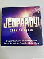 Front view of the boxed Jeopardy 2025 Calendar showing title and branding.