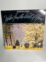 Front cover of Johnny Cash vinyl album 'Water from the Wells of Home' showing a scenic image with title and artist name.