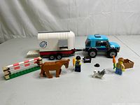 Full set showing SUV, horse trailer, horse figure, dog, two minifigures, fence, and accessories.
