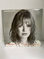 Front cover of Marianne Faithfull's Dangerous Acquaintances album showing a close-up portrait photo of the artist with wet hair.