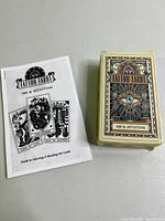 Lot contents showing Tattoo Tarot deck box and reprinted guidebook booklet