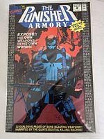 Front cover photo showing The Punisher Armory Issue #2 comic book with detailed artwork and weapon names on cover.