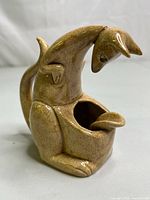 Side view of the hand-painted ceramic kangaroo ashtray showing the open mouth bowl section, curved tail, and detailed sculpted features.