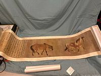 Wide view of the open scroll showing two horses and calligraphy text with red seals.