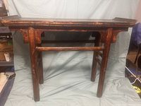 Front view of Chinese Ming style altar table showing scrolled ends and bracket-form apron