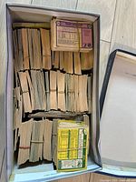 Overhead view of white box filled with bound stacks of hockey cards secured with rubber bands
