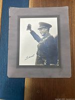 Full view of the Prince of Wales photograph, mounted on grey matte board showing him in military uniform raising his right arm.