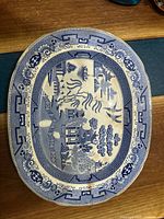 Full view of the oval English Blue Willow motif platter, showing entire surface and decorative border.