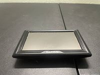 Front view of Garmin GPS device showing screen and Garmin branding.