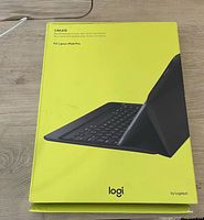Front of Logitech Create keyboard case box for iPad Pro, yellow packaging showing image of keyboard and case connected to iPad.