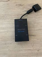 Top view of Sony PlayStation 2 Multitap adapter showing Sony logo, multitap label and PlayStation 2 logo.