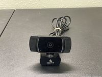 Front view of the NexiGo USB webcam showing the lens and attached cable.