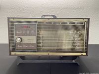 Front view of vintage Arvin Instant Electric Heater showing control panel, knob, and mesh grill.
